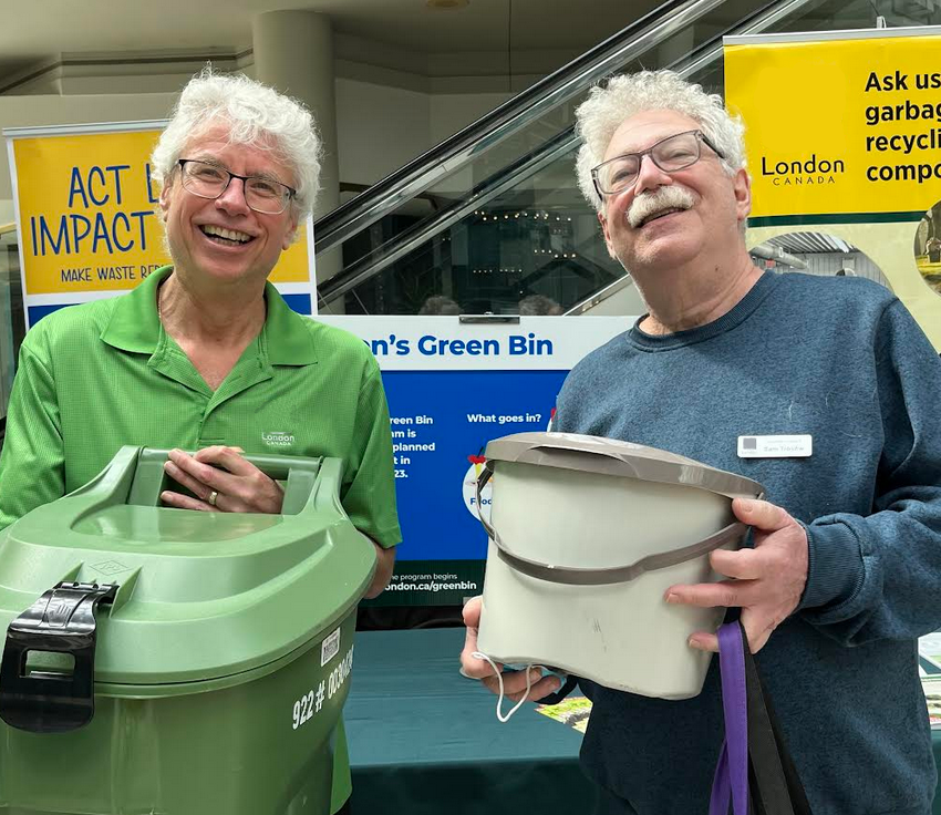 A picture of Sam with city staff, both holding green bins